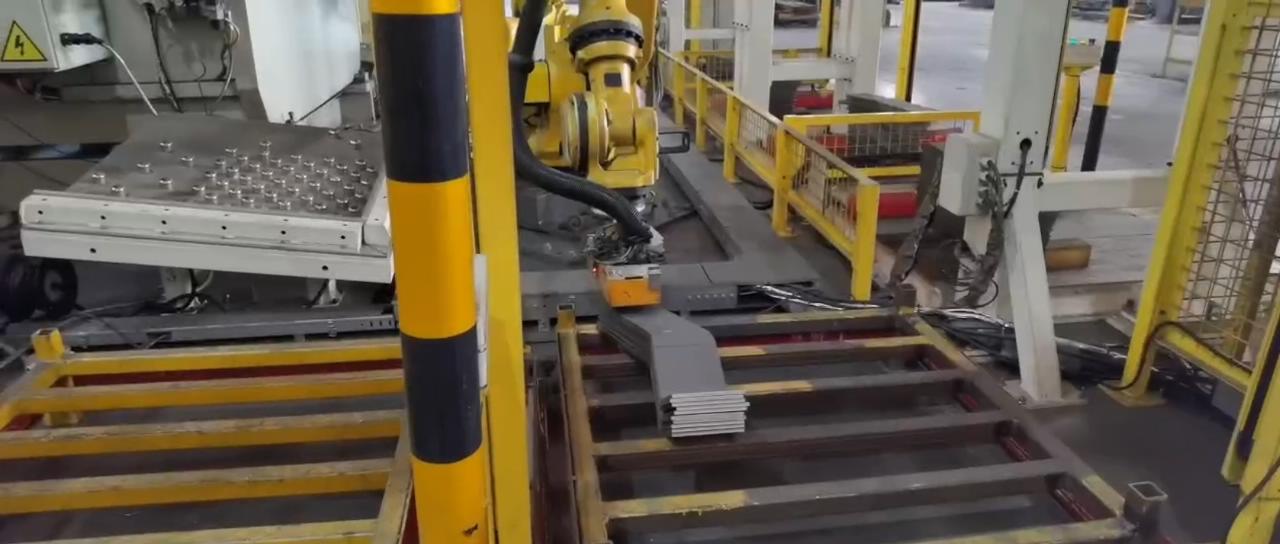 Magnetic robot gripper palletizing the bent strip