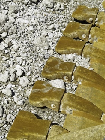 Rusty rocklike teeth on bucket of a track loader on construction site-1